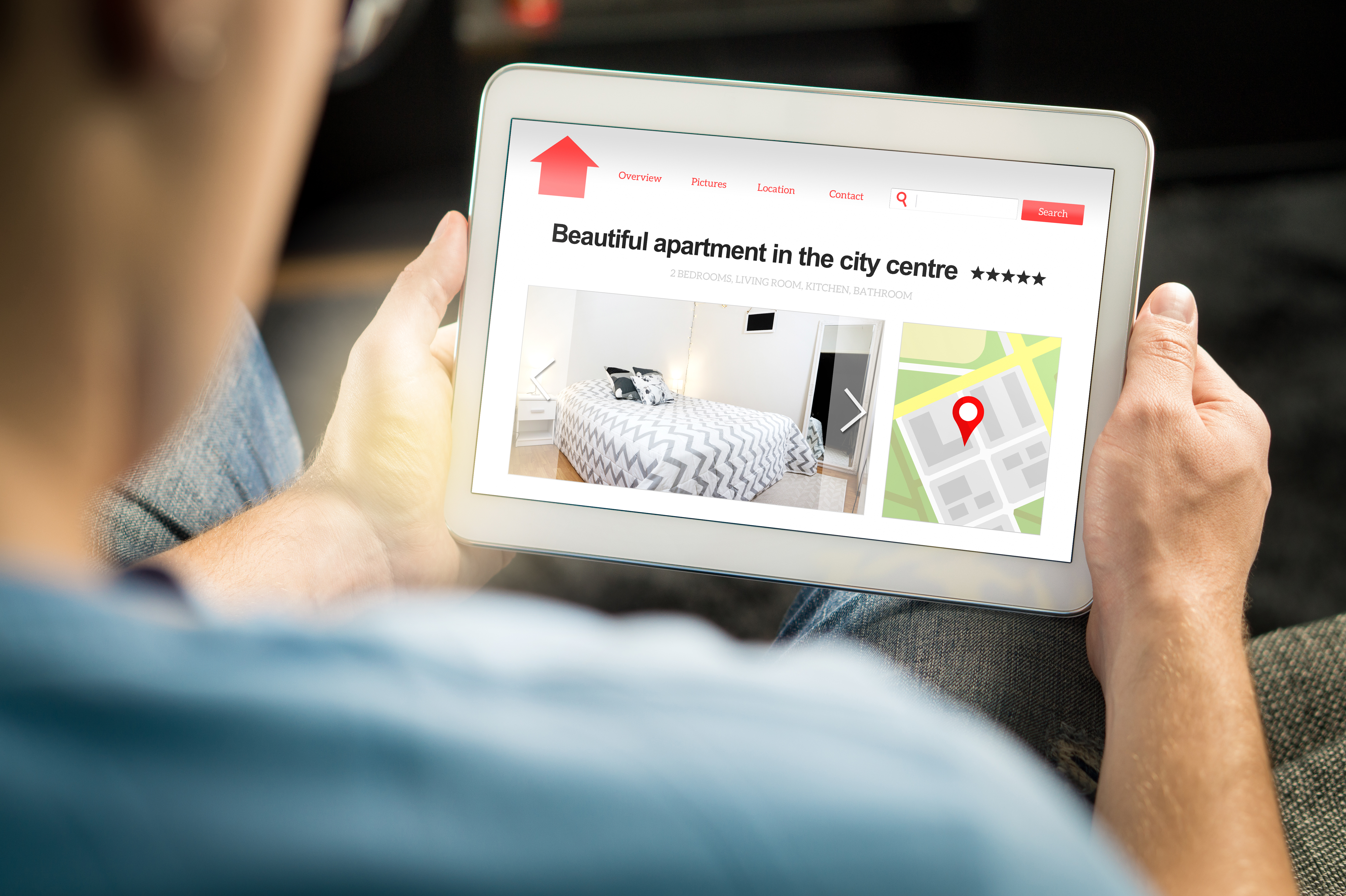 Man making a rental booking using a tablet
